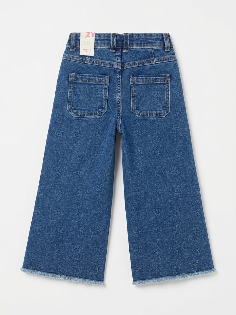 Vaqueros niña zippy Girl campana wide leg denim azul medio costuras verticales cremallera botones metálicos cintura ajustable gomas botones interiores bolsillos parche bajo deshilachado