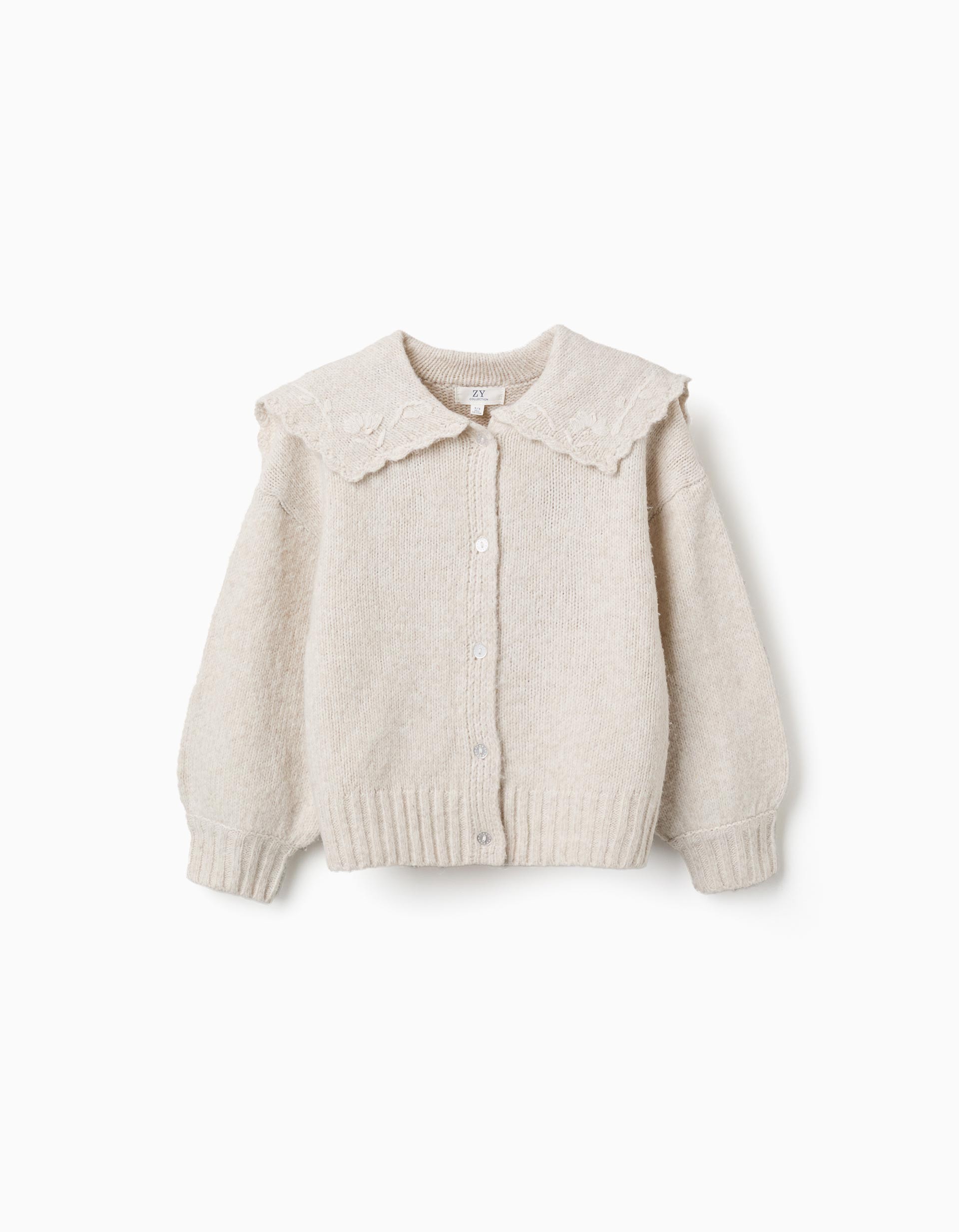 Rebeca niña Zippy Collection punto beige claro crema cuello babero volantes bordados florales hojas botones frontales mangas largas abullonadas puños acanalados bajo acanalado