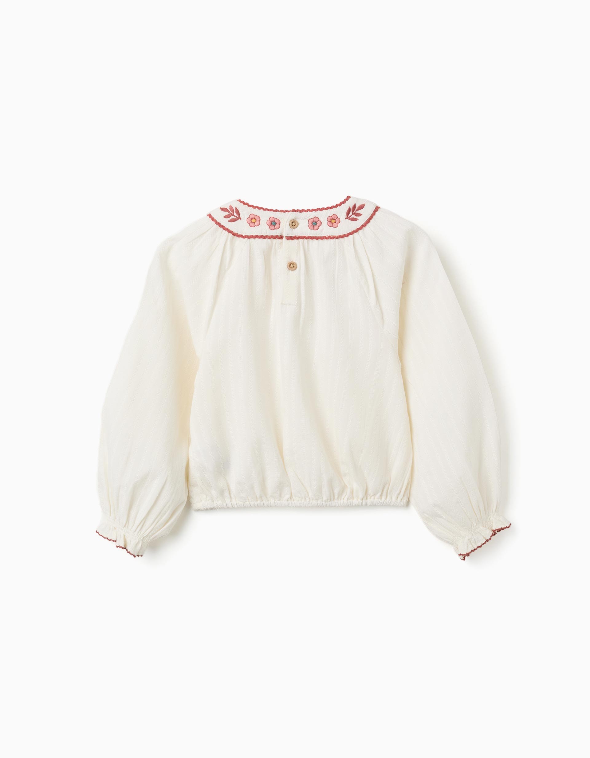 Blusa niña blanco roto cuello redondo bordado floral rojo rosa azul ribete festoneado mangas abullonadas puños elásticos bajo elástico botones madera espalda