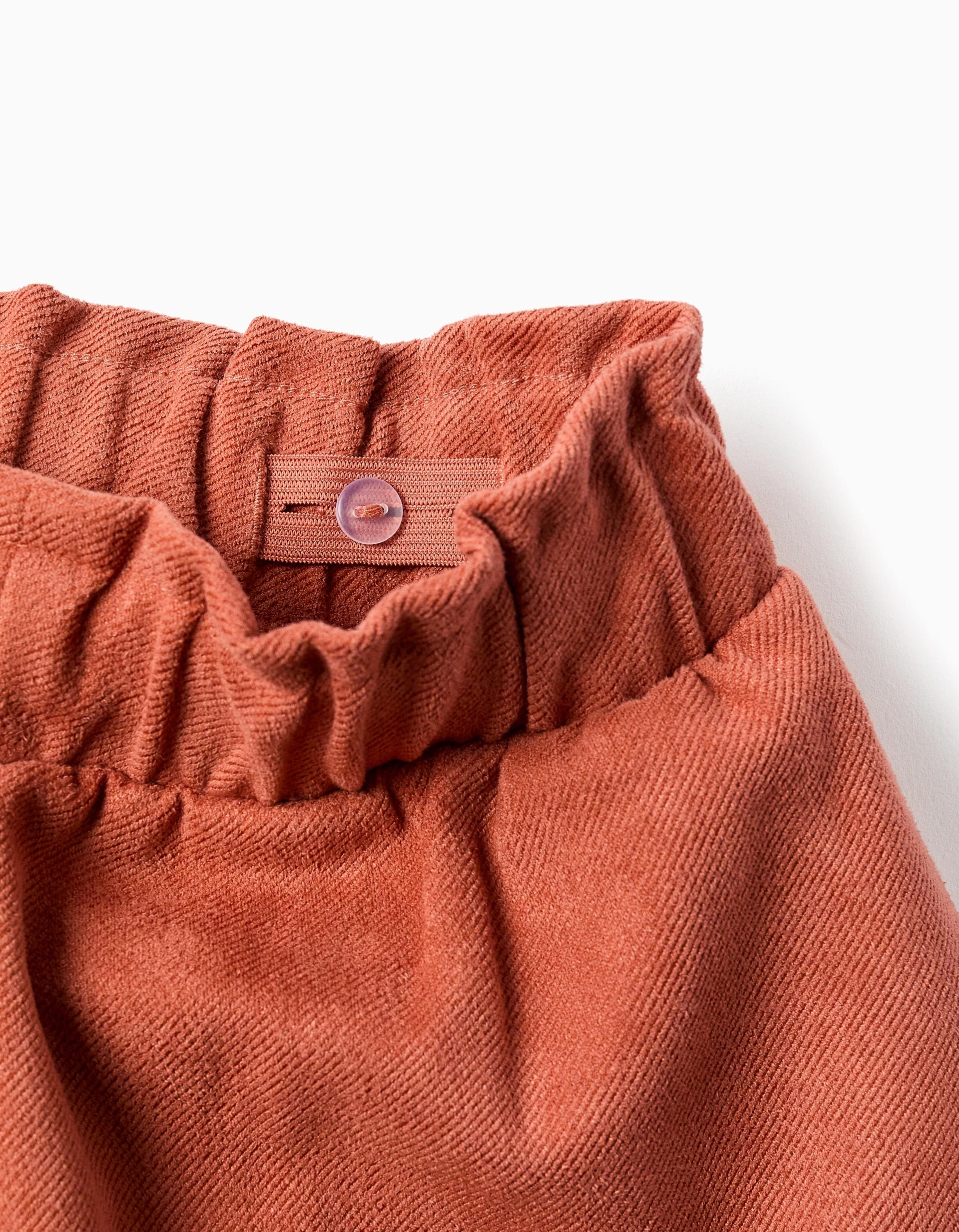 Shorts niña pana fina teja terracota cintura elástica paperbag lazo decorativo bolsillos laterales botón interior ajustable